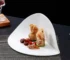 European white striped ceramic irregular shaped plates on a table