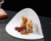 European white striped ceramic irregular shaped plates on a table