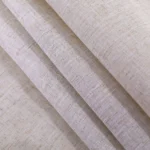 Round linen tablecloth with tassels on a dining table