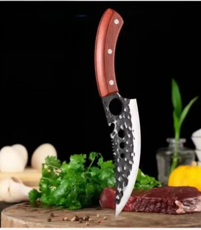 Goldoma scimitar chef knife slicing through raw meat on a cutting board