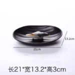 Black melamine dinner plates stacked elegantly on a wooden table