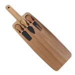 Acacia cheese board set with cheese knives and wooden cutting board on a table