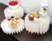 White cardboard dessert table risers set of 5 displaying cupcakes and drinks on a party table