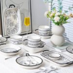 Elegant 20-piece porcelain dinnerware set arranged on a table, showcasing bowls and plates in a gift box