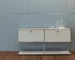 Modern modular sideboard with stainless steel frame and wooden doors in living room
