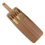 Acacia cheese board set with cheese knives and wooden cutting board on a table
