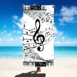 Vibrant guitar beach towel with colorful musical notes pattern on a sandy beach