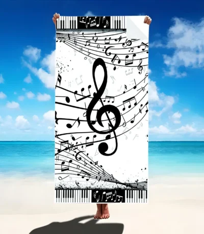 Vibrant guitar beach towel with colorful musical notes pattern on a sandy beach