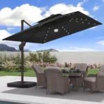 Goldoma large patio umbrella with lights illuminating a 9x9 FT square cantilever umbrella with solar LED lights in a bac