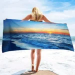 Ocean sunset pattern quick dry beach blanket on sandy beach with waves in background