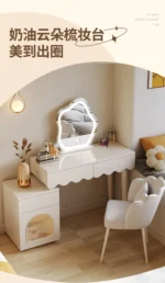Modern makeup vanity desk with mirror and stool in a bedroom setting, showcasing ample storage and elegant design