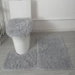Plush bathroom rug set with toilet lid cover and mat in a cozy bathroom