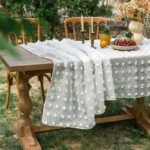 Retro polka dot tablecloth with fringe on a wooden table