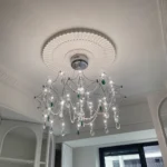 Modern stainless steel chandelier with crystal LED lights in a living room