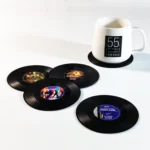 Set of vinyl record coasters on a wooden table