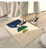 Modern abstract art non slip bathroom rug with vibrant colors and textured surface on a bathroom floor