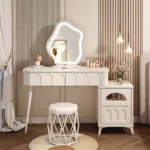 Modern wood makeup vanity table with mirror, drawer, and stool in a bedroom setting