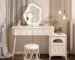 Modern wood makeup vanity with stool, featuring a mirror and drawer in a bright bedroom