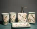 Flowers ceramic toothbrush holder on bathroom counter, white with floral pattern, holding two toothbrushes.