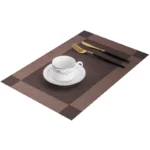 Gold weave placemats on a dining table with plates and cutlery