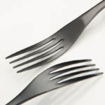 Luxury black 18/10 stainless steel cutlery set arranged on a table
