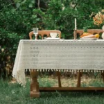 Retro polka dot tablecloth with fringe on a wooden table