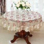 Elegant lace tablecloth with rose gold embroidery on a dining table
