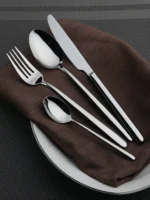 Goldoma 24-piece stainless steel cutlery set on a wooden table