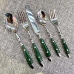 Elegant stainless steel cutlery set with fork, knife, and spoon on a wooden table