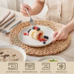 Elegant ceramic plates set with dinner plates, dessert plates, cereal bowls, and soup bowls arranged on a wooden table