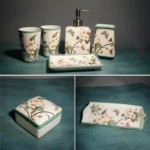 Ceramic toothbrush holder with flowers, on black marble counter, contrast.