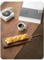 Elegant walnut cutting board with French vintage design, perfect for bread, cheese, and fruit presentation