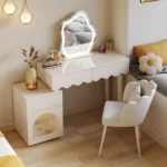 Modern makeup vanity desk with mirror and stool in a bedroom setting, showcasing ample storage and elegant design