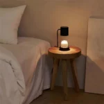 Retro metal lamp base with textured finish, simple table lamp design, on an office desk.