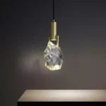 Modern crystal pendant lamp illuminating a dining room with elegant light refraction