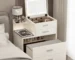 French modern white vanity desk with mirror and stool in a bright bedroom