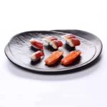 Black melamine dinner plates stacked elegantly on a wooden table