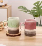 Large ceramic coffee mug with retro design and handle on wooden table
