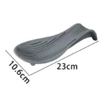 Silicone spoon rest holding a wooden spoon on a kitchen counter