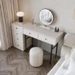 Modern minimalist makeup vanity table with mirror and stool in a bedroom setting