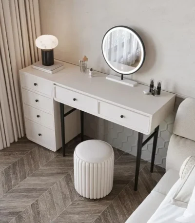 Modern minimalist makeup vanity table with mirror and stool in a bedroom setting