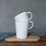 Enamel baking measuring cup with dual scale markings on a kitchen counter