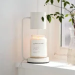 Birds-eye view of the lamp with a wax melt dish, surrounded by office decor items.