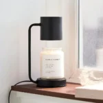 Lamp turned on with low dimming, casting soft light on a wooden table in a home office.