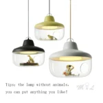 White glass pendant light hanging over a wooden dining table, soft illumination for family meals