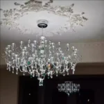 Modern stainless steel chandelier with crystal LED lights in a living room