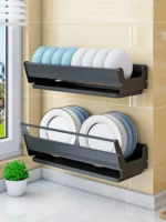 Stainless steel wall mounted dish rack holding plates and bowls in a modern kitchen