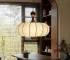 Walnut wood chandelier with fabric shades in a cozy living room