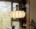 Walnut wood chandelier with fabric shades in a cozy living room