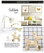 Gold balloon dog on a black lacquer desk with a monitor.